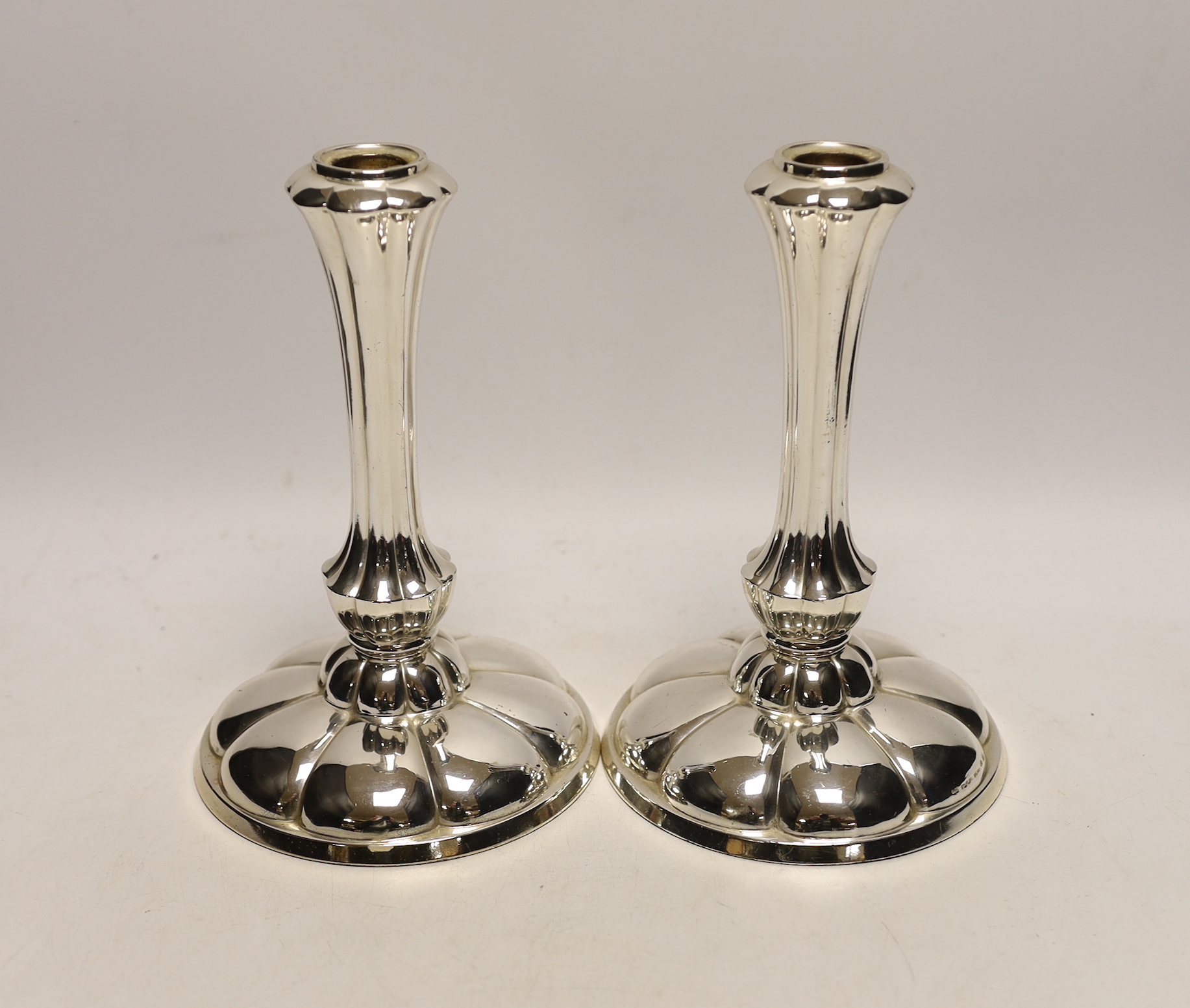 A pair of early 20th century German 800 white metal mounted fluted design candlesticks by Gayer & Krauss, height 20.3cm, weighted.